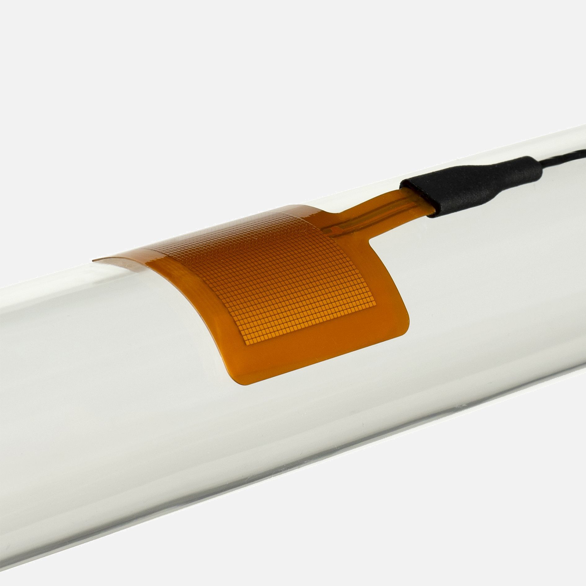 A flexible FHF05 heat flux sensor mounted on a pipe to measure insulation effectiveness and thermal energy loss.