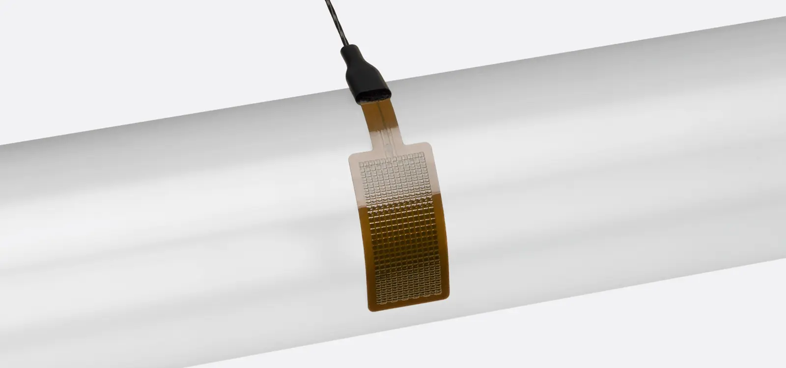FHF06 heat flux sensor being bent to show its flexibility, with a rated bending radius of 7.5 millimeters.