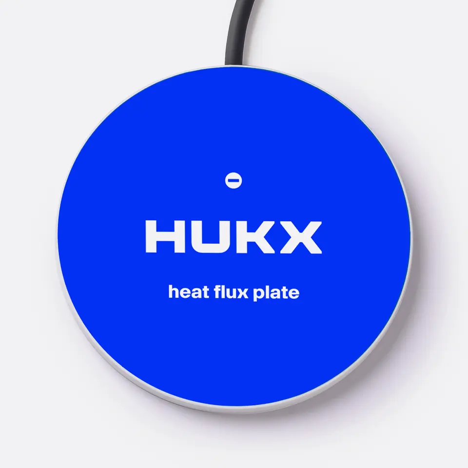 Top-down view of the HFP01 heat flux plate showing the flat mounting side and the waterproof cable entry point.
