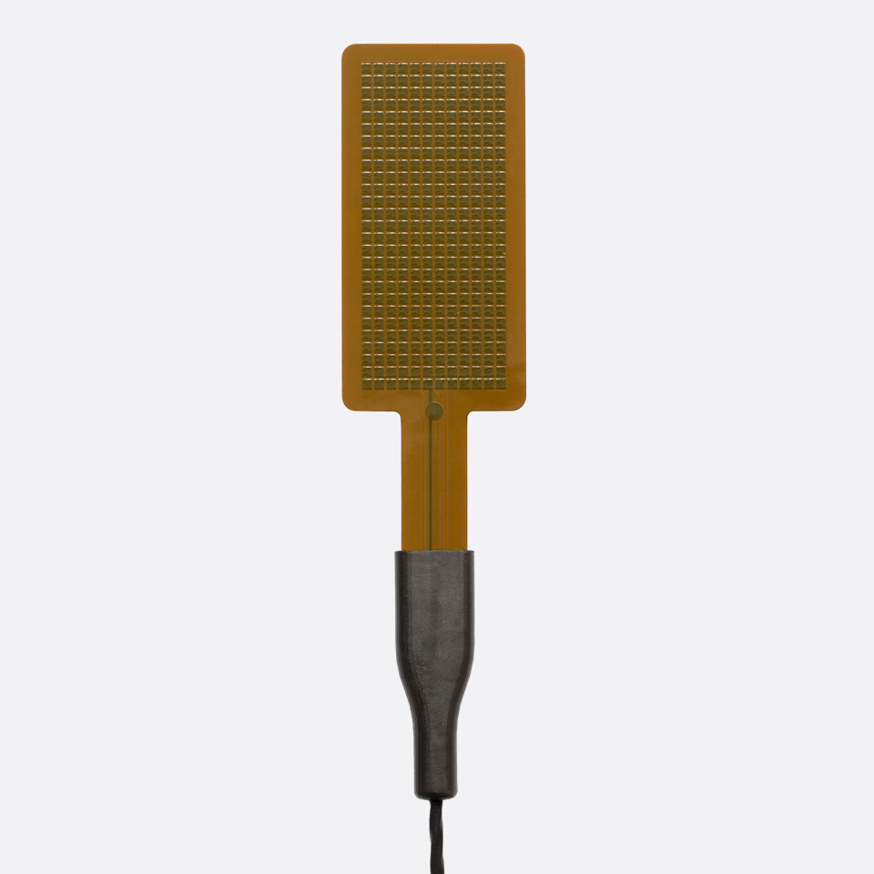 Close-up of the FHF06 high-temperature foil heat flux sensor with integrated Type T thermocouple for up to 250°C.